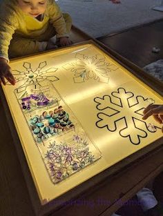 a young child is playing with an art project