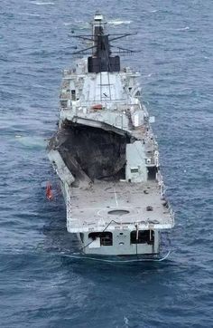 an aircraft carrier floating on top of the ocean