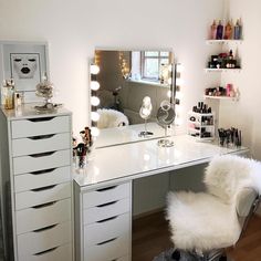 a white desk topped with a mirror and lots of drawers