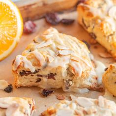 an orange and cranberry scones on a cutting board