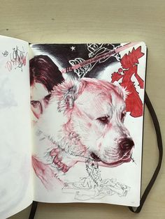 an open book with a drawing of a dog and a man's face on it