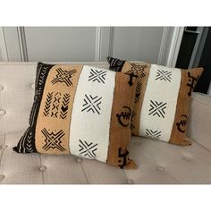 three decorative pillows sitting on top of a couch