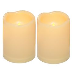 two yellow candles sitting next to each other