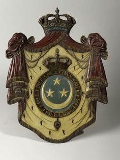 an ornate clock with a crown on it's top and stars in the middle