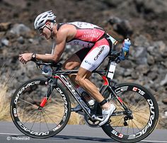 a man riding a bike on top of a road