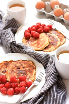 pancakes with raspberries and coffee on a table