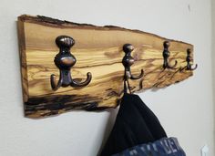 a coat rack made out of wood with hooks