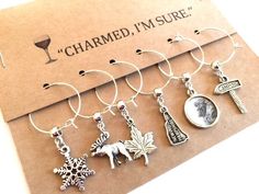 six wine charms with the words charmed i'm sure on them and an image of a woman