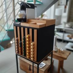 a wooden and metal rack with abacuss on it in front of a stair case