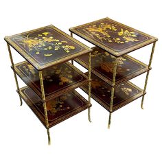 a set of three nesting tables with floral designs on each side and gold trimmings