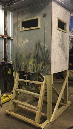 a metal structure with graffiti on it in a garage