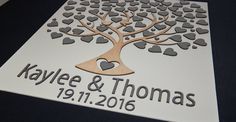 a wedding guest book with a tree and hearts on it that reads, kayle & thomas 19 11 2016