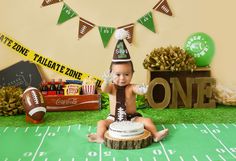 a cake that looks like a football player sitting on top of a table with decorations