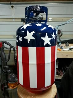 an old propane gas can painted like the american flag with stars and stripes on it