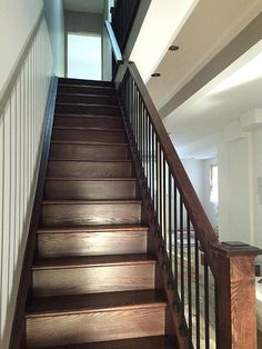 the stairs are made of wood and have handrails that lead up to the second floor