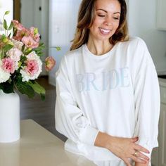 Radiate Throughout Your Bridal Events With Our Bride Millie Sweatshirt. Combining Timeless Elegance With A Hint Of Sparkle, It Offers Both Comfort And Style As You Prepare For Your Big Day. With Buttery-Soft Fabric And Cozy Fleece Lining, It Ensures Unparalleled Comfort For The Bride-To-Be. Perfect For Bachelorette Weekends, Wedding Appointment, Or Getting Ready On The Morning Of Your Special Day! Xs= 2-4 S= 6-8 M= 8-10 L=12-14 Relaxed Fit Crew Neck Top For Wedding, White Relaxed Fit Top For Wedding, Scarf Coverup, Rebecca Black, Bridal Events, Bride Sweatshirt, Kids Scarf, Bridal Event, Bachelorette Weekend