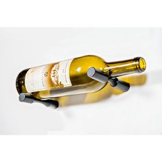 two bottles of wine are attached to the side of a bottle holder on a wall