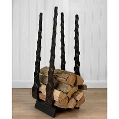 a stack of firewood sitting on top of a wooden floor