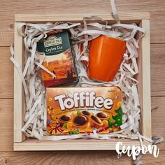 an orange cup and some coffee in a box