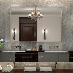 a fancy bathroom with marble walls and black counter tops, along with white towels on the floor