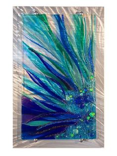 blue and green glass art piece with bubbles on it