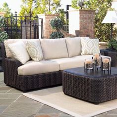 an outdoor living room with wicker furniture