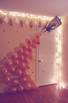 a bunch of balloons hanging from the side of a wall next to a mirror with lights on it