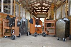 there are many different types of saddles in this barn