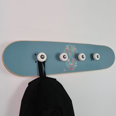 a skateboard mounted to the wall with eyeballs on it's back end