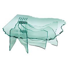 a glass table with four forks on top of it, and three pieces of plastic in the middle