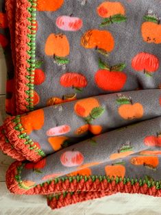 an orange and gray blanket with pumpkins on it