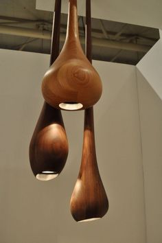 three wooden objects hanging from the ceiling