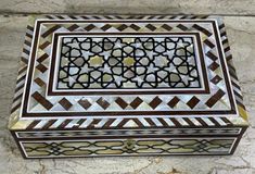 a decorative box sitting on top of a marble floor