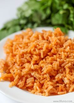 a white plate topped with rice next to lettuce