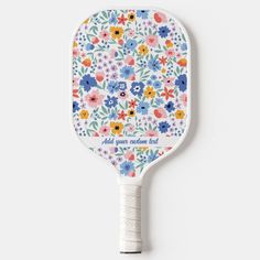 a colorful flowered paddle with the words, all you need is love