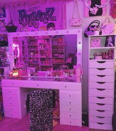 a room filled with lots of pink furniture and accessories on top of a purple rug