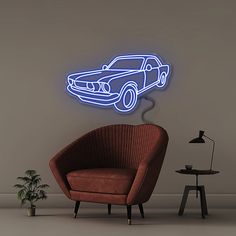 a chair sitting in front of a wall with a neon car on it's side