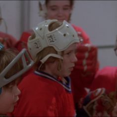 the young hockey players are wearing their helmets