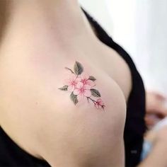 a woman's breast with pink flowers on it