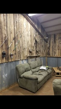 a living room filled with furniture and wooden walls