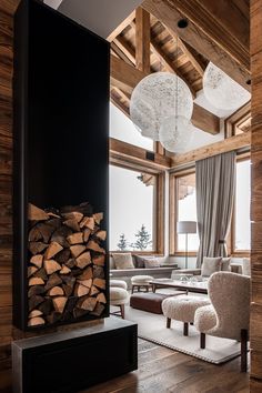 a living room filled with furniture next to a firewood log pile on top of a hard wood floor