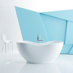 a white bathtub sitting next to a chair and table in a room with blue walls