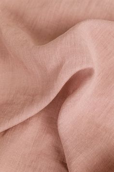 a close up view of the fabric on a pink shirting material that is very soft