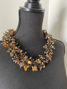 Accessories are a great way to revamp an outfit--and a statement necklace is the way to go. This beaded statement Bib necklaces is great for dressing up your party dresses with wow-effect. The necklace is beaded using Czech glass seed beads, glass flowers and glass leaves. Golden brown honey colors combination makes this necklace rich, bright with luxurious look. The necklace measures approximately 53 cm and ended with filigree dragonfly clasp. It is called a statement necklace for a reason--it Costume Jewelry Beaded Choker Necklace, Crystal Headpiece Wedding, Prom Hair Accessories, Silver Head Piece, Beaded Bib Necklace, Pearl Headpiece, Knit Jewelry, Floral Accessories Hair, Silver Mermaid