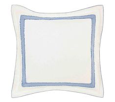 a blue and white pillow with a square border on the bottom, in front of a white background