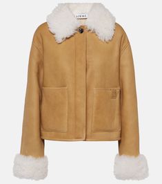 Shearling-trimmed leather jacket in brown - Loewe | Mytheresa Winter Leather Jacket With Suede Lining, Luxury Shearling Leather Jacket For Work, Luxury Winter Outerwear With Contrast Collar, Designer Shearling Leather Jacket With Padded Collar, Luxury Shearling Outerwear With Padded Collar, Chic Leather Jacket With Faux Fur Trim, Luxury Shearling Leather Jacket With Faux Fur Lining, Designer Sheepskin Leather Jacket For Fall, Chic Shearling Leather Jacket For Work