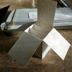 an open box sitting on top of a table next to a binder and pen