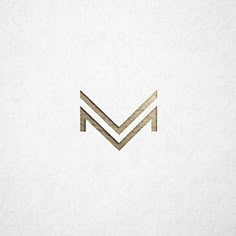 the letter m is made up of gold foil and has a diagonal stripe on it