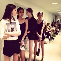 three models are standing in front of a mirror