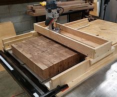 a piece of wood being cut into pieces with a power tool on top of it